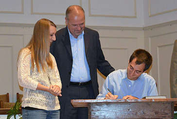 Congregations from Easley and Cleveland, Ohio, join hands to reach Buckeye State Cleveland, Ohio-area planter Tony Loseto signs a partnership agreement with Mt. Airy Baptist Church in Easley as his wife, Beth, and Mt. Airy pastor Keith Shorter look on.
