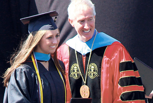 Mary Lee Bailes receives her degree from NGU president Jimmy Epting.