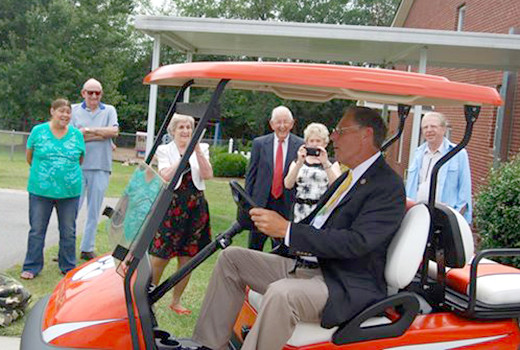 Kimmett Lott receives golf cart from congregation