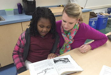 Emory Hiott reads with her buddy, Morgan.  Morgan's reading has improved so much that she has been accepted into the gifted and talented program.