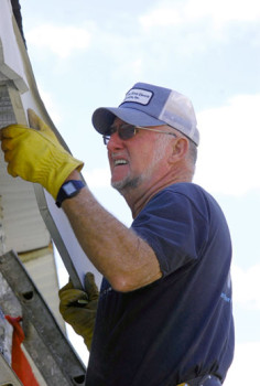 Campers-on-Mission_0456_online A volunteer with South Carolina Campers on Mission repairs the eaves of an aging church building in Anderson.