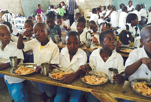 Mackenzie's mission team made lunch for school kids in Bigarade, and also provided funds to help build a kitchen at the school. (Photo by Mary Russell)