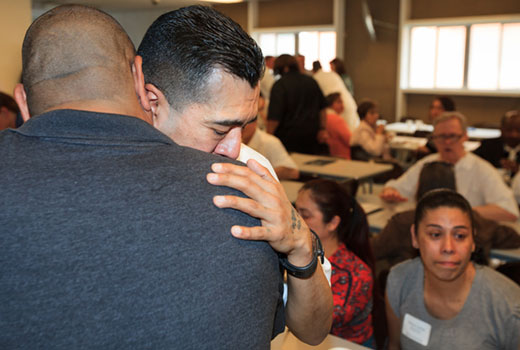 Michael Rios, a graduate of Southwestern Seminary’s Texas prison extension seminary program, hugs a family member following the May 9 commencement. (SWBTS Photo/Matt Miller)