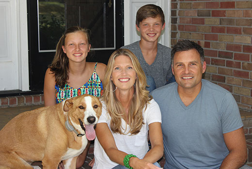 Wendy and Scott Duke relax on the porch with their kids, Savannah, 15, and J.P., 12, and their dog, Charlie.