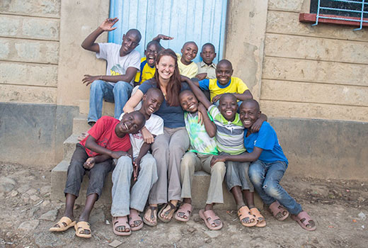 Kristen Lowry (formerly Kristen Sayres) poses with boys living at the Naivasha Children's Shelter in Naivasha, Kenya. She had served as the shelter's co-director for two years, and proceeds from her "bride price" will benefit the shelter. (Photo courtesy of Kristen Lowry)