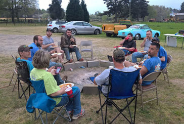 Enjoying a lunch of fried catfish brought by a volunteer, a Bugs 4 Christ group, including BCM members from Georgia College, take a break from restoring a '74 Volkswagen Super Beetle. (Bugs 4 Christ photo)