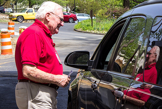 Volunteer Jim Hill welcomes visitors to LifeWay's Ridgecrest Conference Center, directing cars and distributing parking hang tags.
