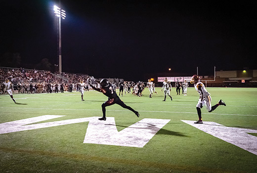 Keaire Wilkins of the Putnam City High School Pirates catches a touchdown pass against rival Putnam City North in Oklahoma City. Wilkins later received a photo of the play through an outreach to the football team by Cherokee Hills Baptist Church. (Photo by Emily Brashier)