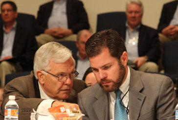 Father-son parliamentarians Jim and Ryan Goodroe confer on a procedural matter.